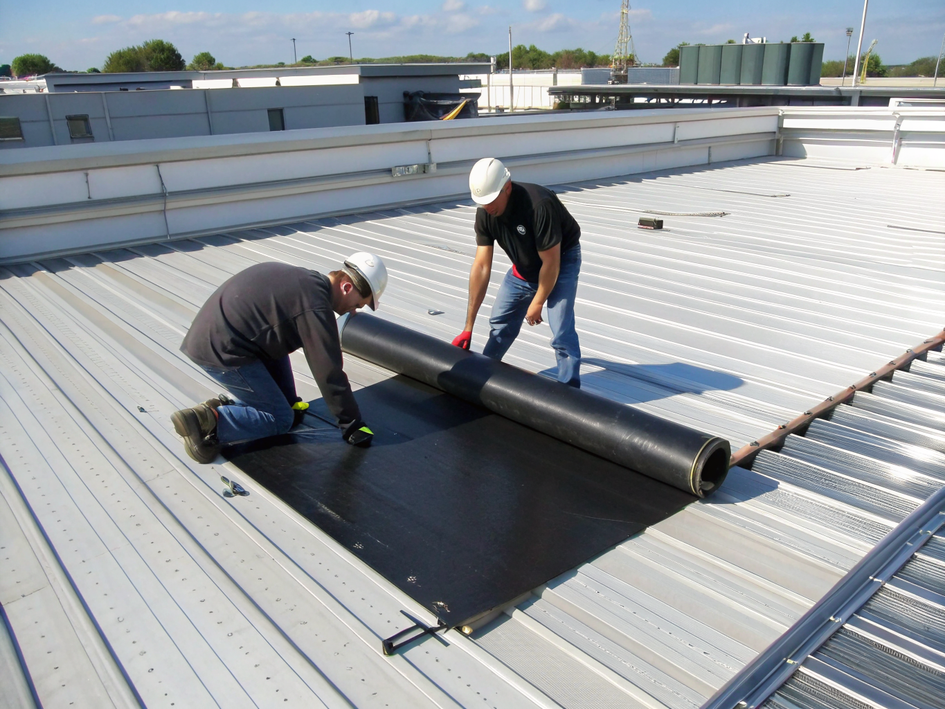 Professional flat roof membrane installation on commercial building