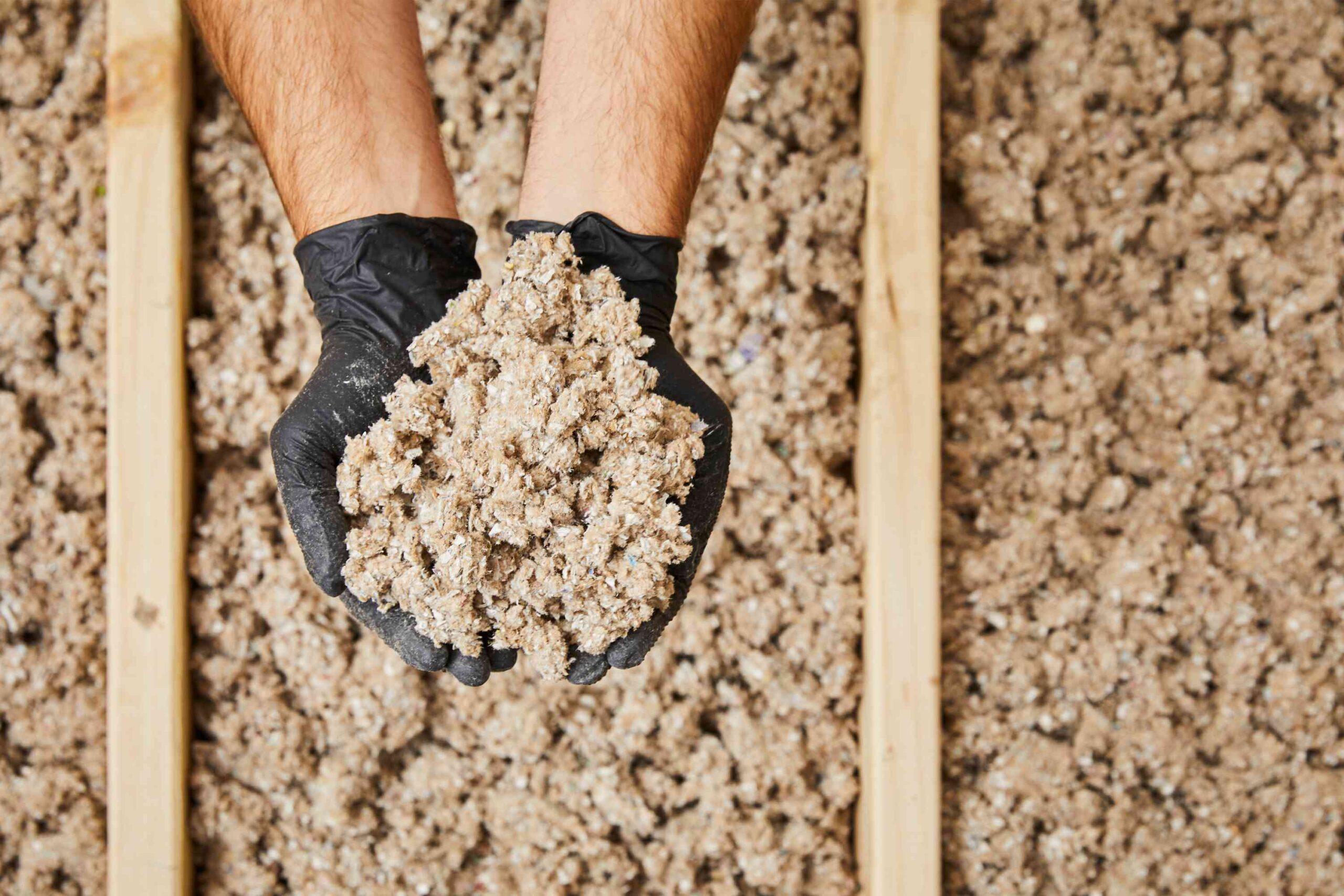 Generic loose-fill grey cellulose insulation in attic